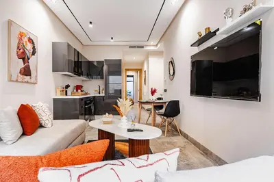a living room with a couch and a table at CFC new Appartement Central Anfa Park roof top free parking in Casablanca