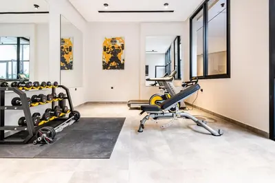 a gym with treadmills and exercise bikes at CFC new Appartement Central Anfa Park roof top free parking in Casablanca