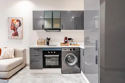 a kitchen with a washing machine and a washer at CFC new Appartement Central Anfa Park roof top free parking in Casablanca