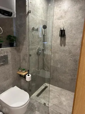 a bathroom with a glass shower with a toilet at CFC new Appartement Central Anfa Park roof top free parking in Casablanca