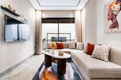 a living room with a couch and a table at CFC new Appartement Central Anfa Park roof top free parking in Casablanca
