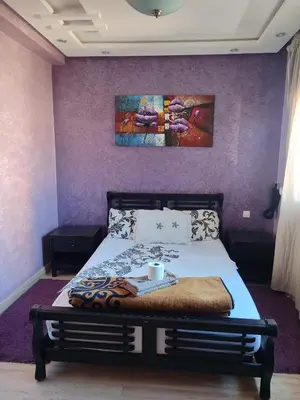a bedroom with a bed with a painting on the wall at Casablanca House hassan2 in Casablanca