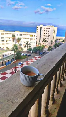 a cup of coffee sitting on a ledge on a balcony at Casablanca House hassan2 in Casablanca