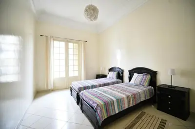 a bedroom with a bed and a window at Cosy Art Deco Apart Welcome to James's in Casablanca