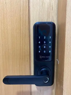 a black remote control attached to a wooden door at Modern Studio Centre Casa belvédère Tramway & Train Station in Casablanca