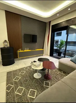 a living room with a couch and a table at A 1 pas de Zara Studio Centrale et Design in Casablanca