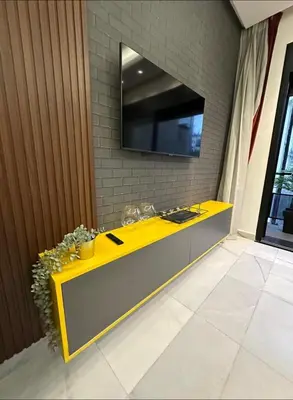 a yellow and gray counter with a television on a wall at A 1 pas de Zara Studio Centrale et Design in Casablanca