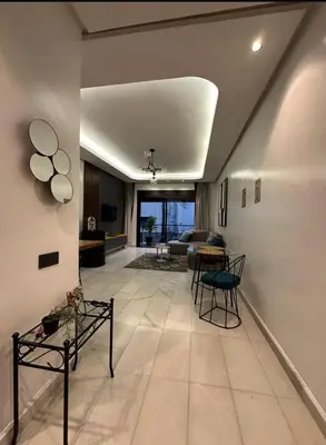 a living room with a couch and a table at A 1 pas de Zara Studio Centrale et Design in Casablanca