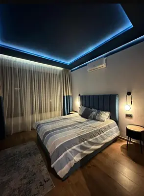 a bedroom with a bed with a blue ceiling at A 1 pas de Zara Studio Centrale et Design in Casablanca
