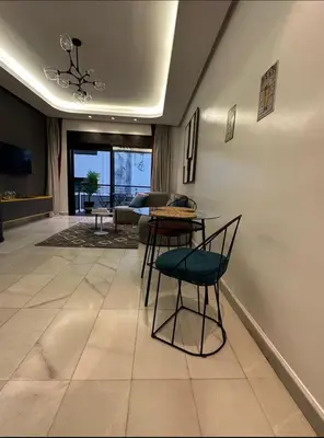 a living room with a table and chairs at A 1 pas de Zara Studio Centrale et Design in Casablanca