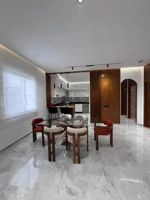 a kitchen and dining room with a table and chairs at Luxury apartment in Rabat