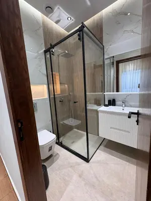 a bathroom with a shower and a toilet and a sink at Luxury apartment in Rabat