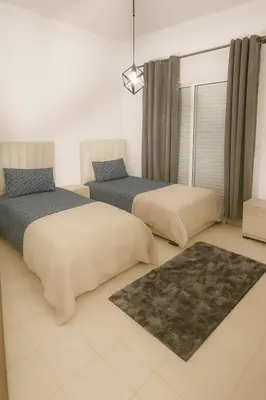 a bedroom with two beds and a window at Casa Bourgogne 2-Bedroom apart, Guarded community in Casablanca