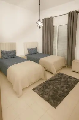 a bedroom with two beds and a window at Casa Bourgogne 2-Bedroom apart, Guarded community in Casablanca