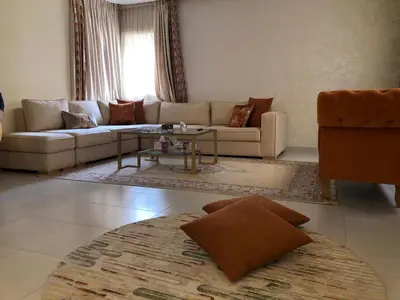 a living room with a couch and a table at AFCON near rabat complex de football in Bouznika