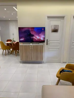 a living room with a large flat screen tv on a wall at AFCON near rabat complex de football in Bouznika