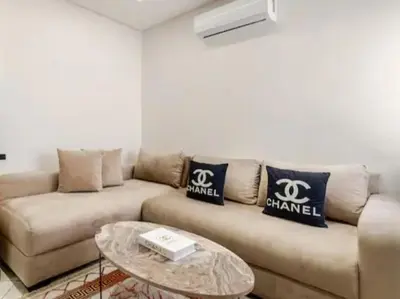 a living room with a couch and a table at Studio charment près de la mosqué Hassan II in Casablanca