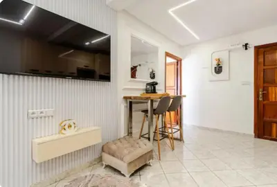 a kitchen with a table and chairs in a room at Studio charment près de la mosqué Hassan II in Casablanca