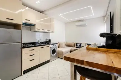 a kitchen with a couch and a table in a room at Studio charment près de la mosqué Hassan II in Casablanca