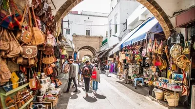 a group of people walking down a street in a market at Studio charment près de la mosqué Hassan II in Casablanca
