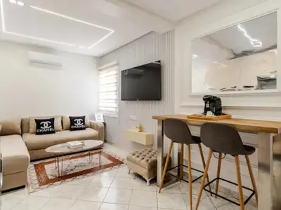 a living room with a couch and a table at Studio charment près de la mosqué Hassan II in Casablanca
