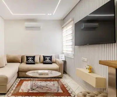 a living room with a couch and a table at Studio charment près de la mosqué Hassan II in Casablanca