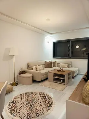 a living room with a couch and a tv at Nouaceur Suite avec Piscine Casa Aéroport AirNest in Nouaseur