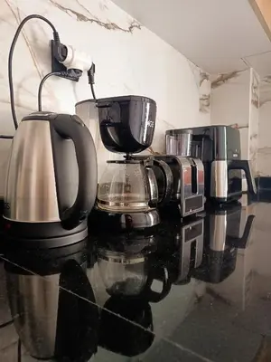a counter with three coffee pots and pans on it at Nouaceur Suite avec Piscine Casa Aéroport AirNest in Nouaseur