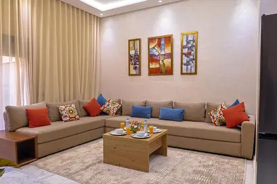 a living room with a couch and a table at Cozy Modern Studio Near Zenâta Beach in Casablanca