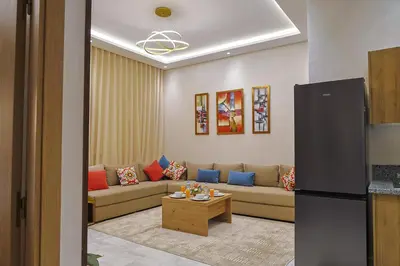 a living room with a couch and a table at Cozy Modern Studio Near Zenâta Beach in Casablanca