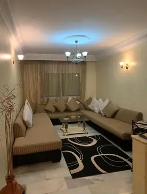 a living room with a couch and a rug at Resedence lettoral in Mohammedia