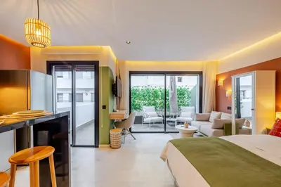 a bedroom with a bed and a living room at Loft - Literie Premium, Fibre optique, IPTV, GYM, Terrasse in Casablanca