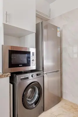 a stainless steel refrigerator and a washing machine in a kitchen at Agdal Train Station Modern&Stylish Apartments in Rabat