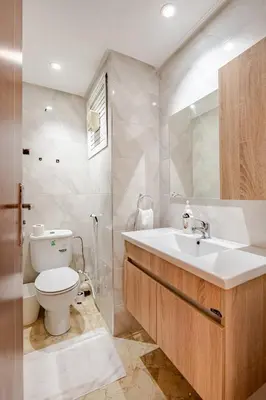 a white bathroom with a toilet and a sink at Agdal Train Station Modern&Stylish Apartments in Rabat