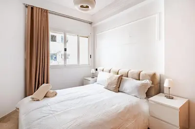 a bedroom with a white bed with a teddy bear on it at Agdal Train Station Modern&Stylish Apartments in Rabat