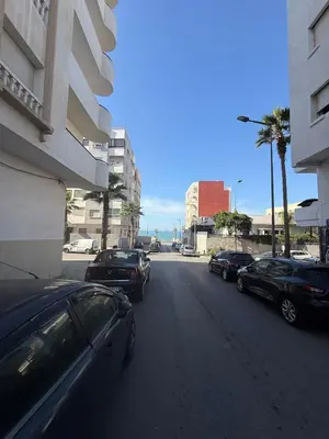 a street with cars parked on the side of a building at Lumineux cosy appartement - océan Rabat in Rabat