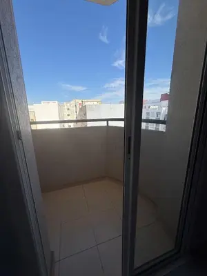 a glass door to a balcony with a view at Lumineux cosy appartement - océan Rabat in Rabat