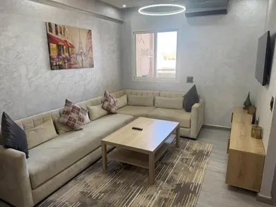 a living room with a couch and a coffee table at Lumineux cosy appartement - océan Rabat in Rabat