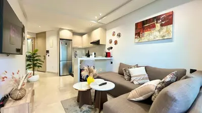 a living room with a couch and a table at Luxurious studio with unobstructed view in Casablanca