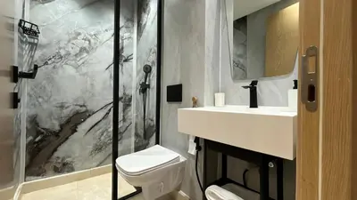 a bathroom with a toilet and a sink and a shower at Luxurious studio with unobstructed view in Casablanca