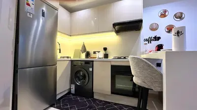 a kitchen with a stainless steel refrigerator and a dishwasher at Luxurious studio with unobstructed view in Casablanca