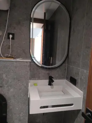 a bathroom with a white sink and a mirror at Studio neuf - haut standing in Casablanca