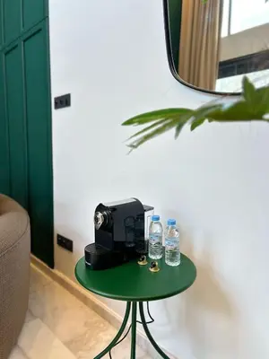 a green table with bottles of water on it at Carrington Stay 13 in Casablanca