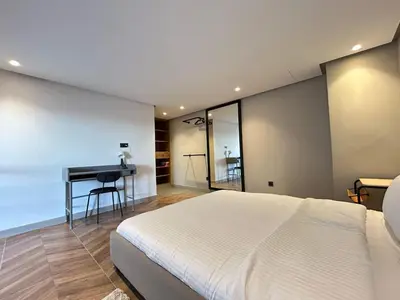 a bedroom with a bed and a desk next to a table at Carrington Stay 13 in Casablanca