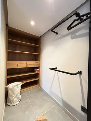 a walk in closet with wooden shelves and a wall at Carrington Stay 13 in Casablanca