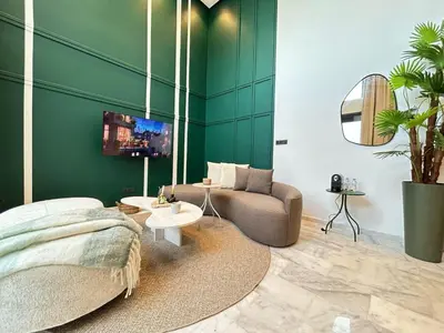 a bedroom with green walls and a bed and a couch at Carrington Stay 13 in Casablanca