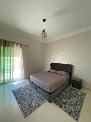 a bedroom with a bed and a rug at Saad in Mohammedia