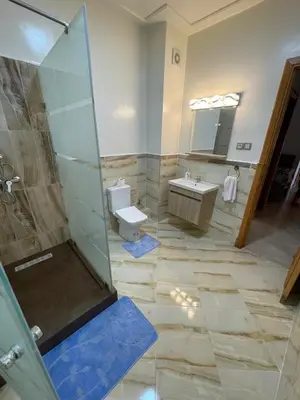 a bathroom with a shower and a toilet and a sink at Saad in Mohammedia
