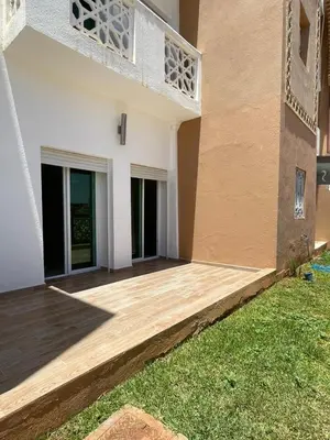 a house with a wooden deck in front of it at Saad in Mohammedia
