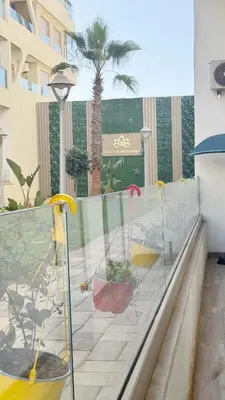 a balcony with a view of a palm tree at Garden paradis bouznika in Bouznika